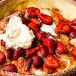 strawberry dutch baby in a cast iron skillet