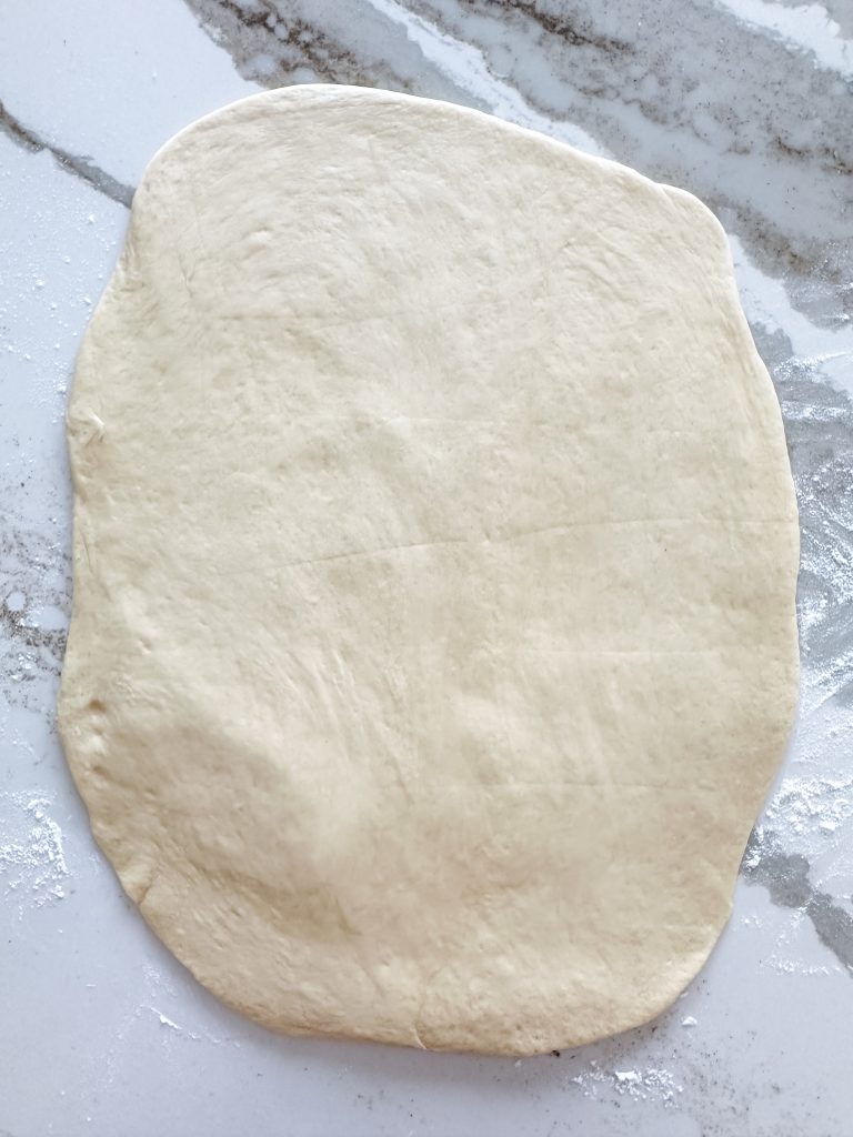 dough rolled out onto surface