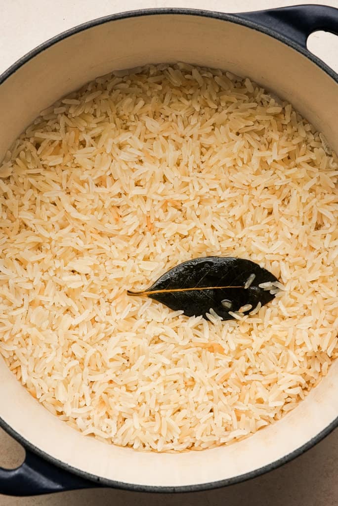 a pot of cooked rice with a bay leaf