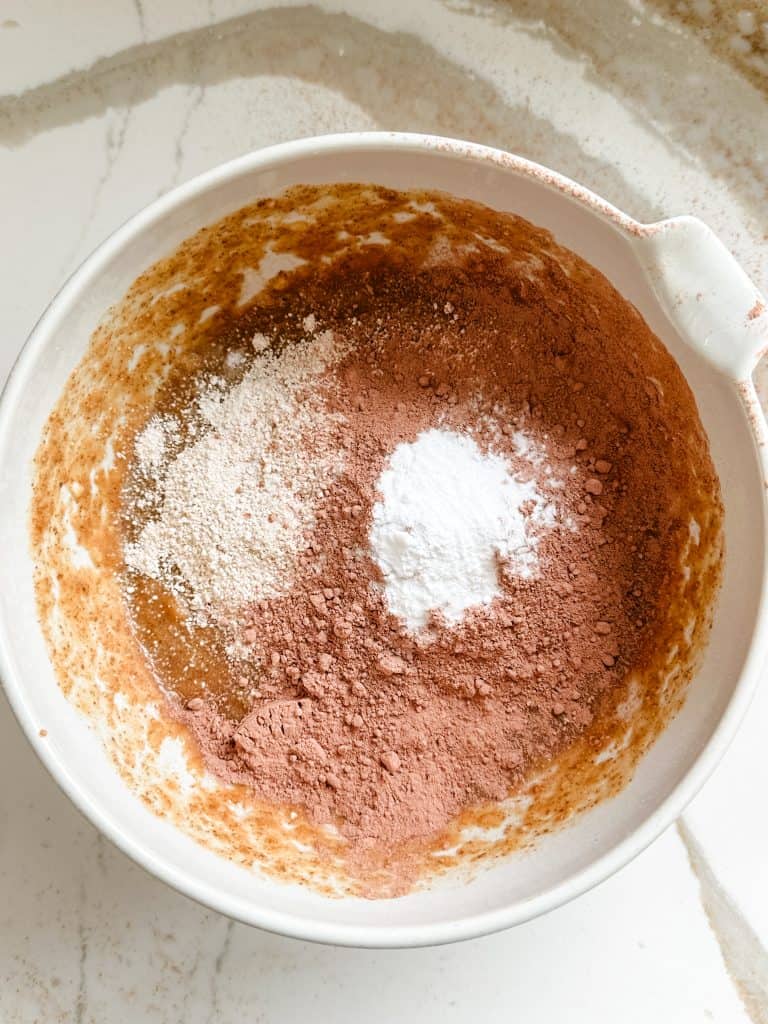 cacao powder, oat flour, baking soda and salt added to the wet ingredients