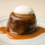 plated sticky toffee pudding with banana topped with whipped cream