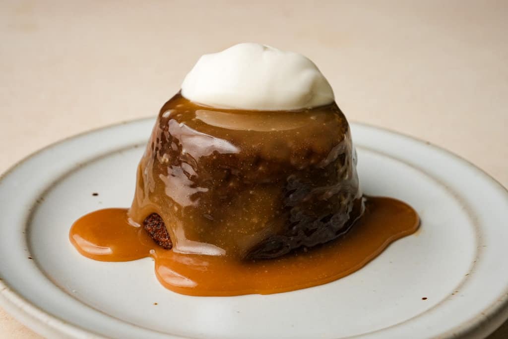 close up view of plated sticky toffee pudding