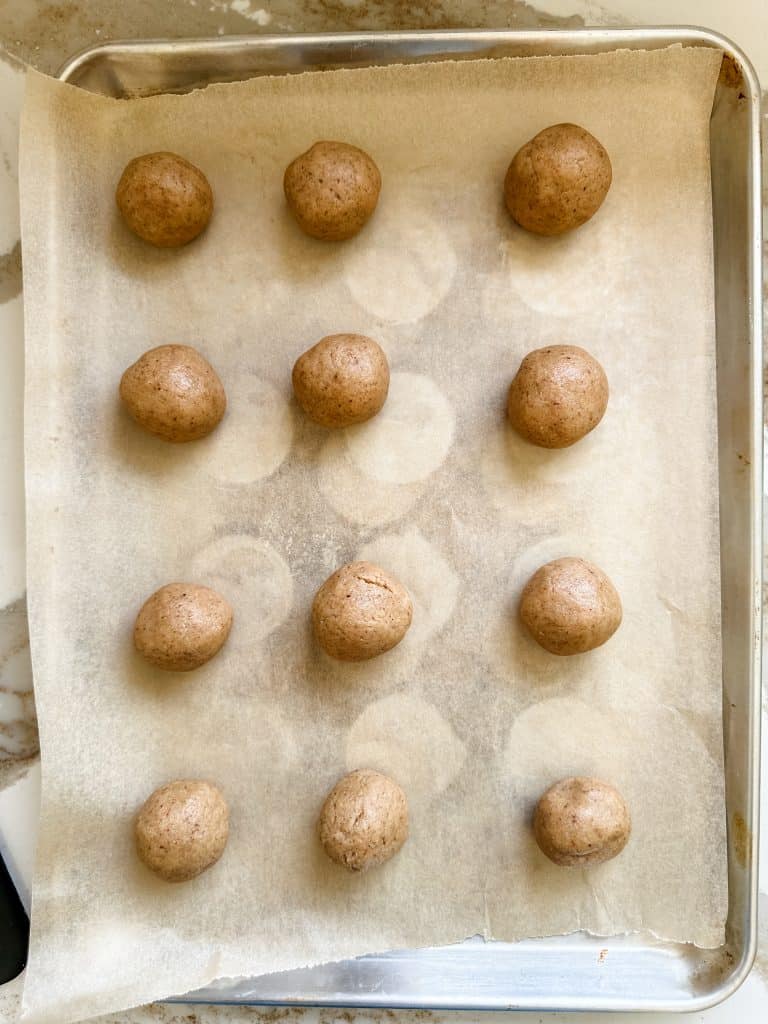 the cookie dough rolled into balls and placed on the baking sheet